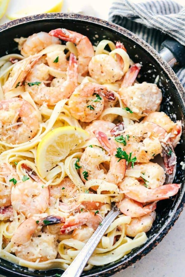 Creamy Parmesan Garlic Shrimp Pasta is the perfect quick and easy meal that is on the dinner table in less than 20 minutes!  Shrimp get coated in the very best creamy parmesan garlic sauce and is wonderful tossed with fresh pasta.