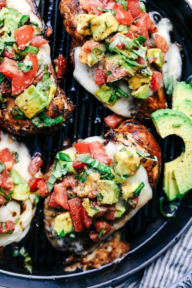 Grilled California Avocado Chicken marinates in an amazing honey garlic balsamic sauce and is grilled to perfection!  It is topped with a thick slice of mozzarella cheese and avocados, tomatoes and basil.  This chicken is INCREDIBLE!!