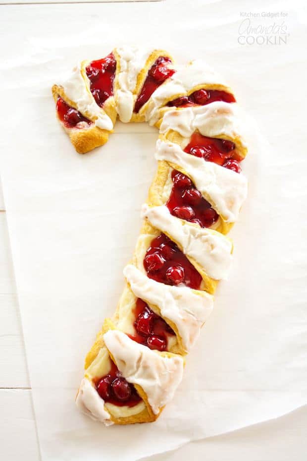 Try this festive Candy Cane Danish – cherry cheese pastry in the shape of a candy cane! This gorgeous candy cane danish is easy to assemble with crescent rolls, cherry pie filling and sweetened cream cheese. It’s a fun Christmas breakfast treat to make with kids!