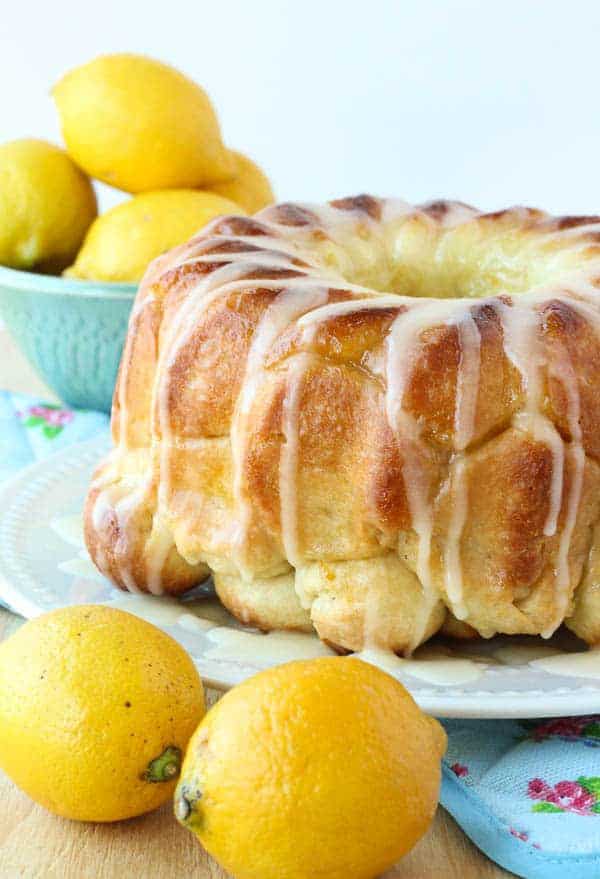 Glazed Lemon Monkey Bread is made with homemade bun dough rolled in lemon sugar, baked, and covered in a thick lemon glaze. The perfect make ahead breakfast, brunch or dessert!