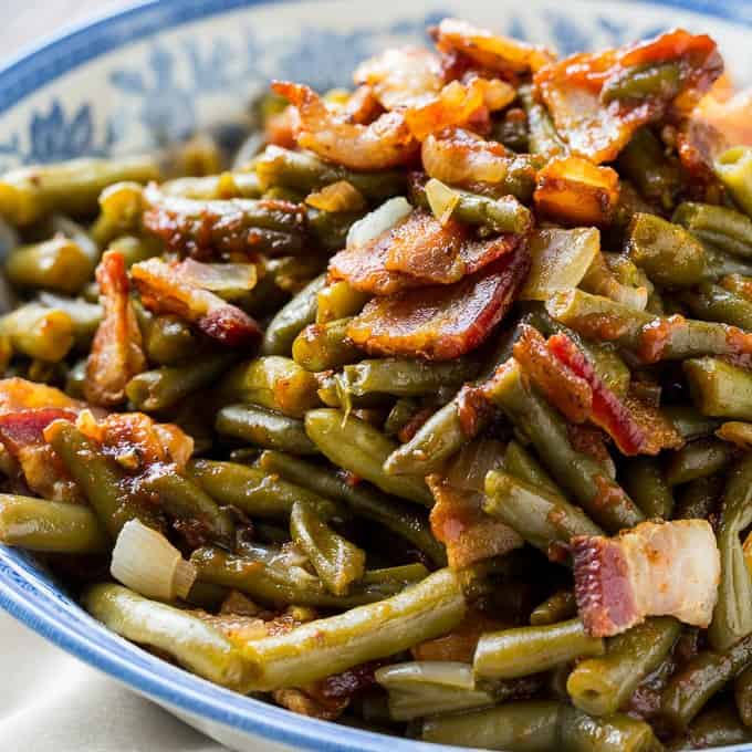Slow Cooker Barbecued Green Beans are sweet and tangy with lots of smoky bbq flavor. Made from canned beans, they are a cinch to make and are a great side dish for potlucks and family meals. They are kind of like the flavor of baked beans, only with green beans. What’s not to love about that?