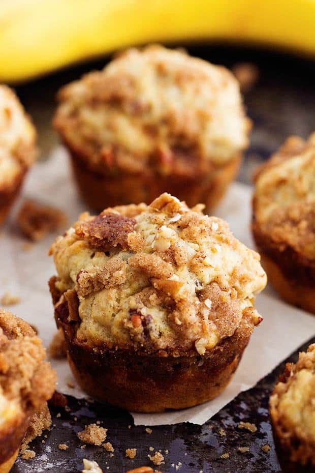 Banana Bread Streusel Muffins - Moist and delicious banana muffins with a crumbly cinnamon streusel topping.  This is such a yummy way to use up those over ripe bananas!