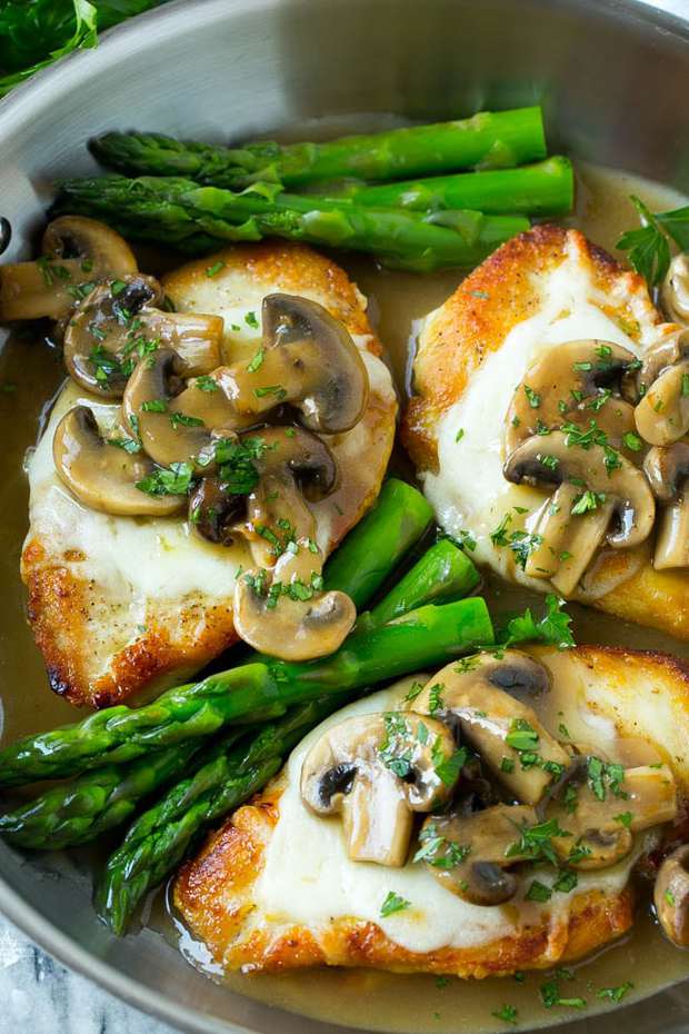 This chicken madeira recipe is even better than the Cheesecake Factory version! Chicken breasts are smothered in mozzarella cheese, the most delicious mushroom sauce, and served alongside asparagus. The perfect dinner for any occasion!