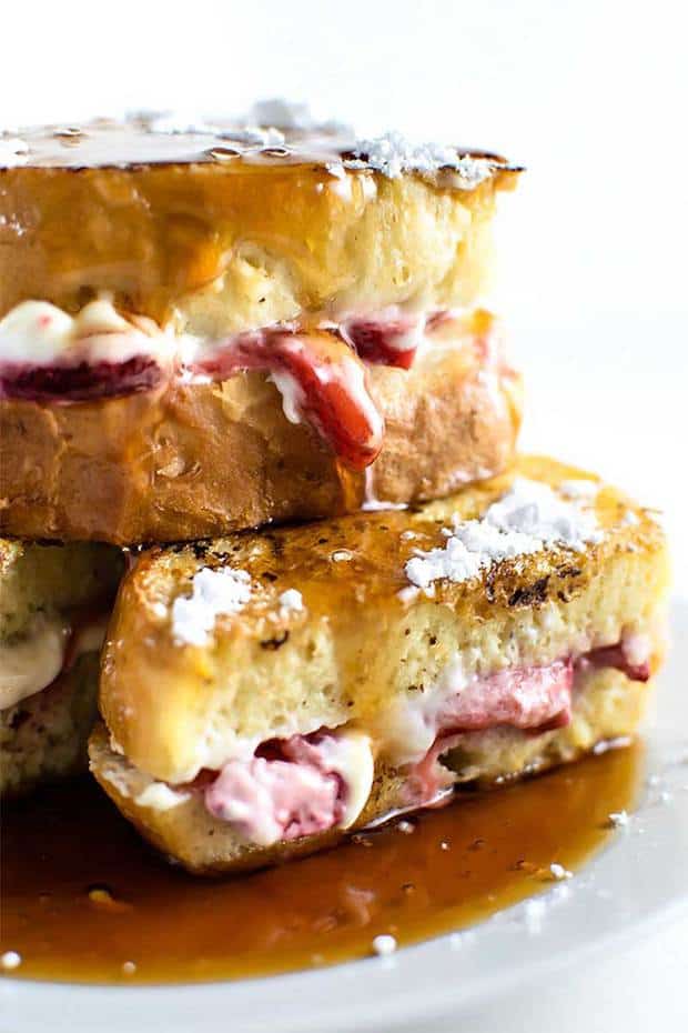 Vanilla and cinnamon french toast stuffed with sweet cream cheese filling and sugar coated strawberries. The classic indulgent breakfast!