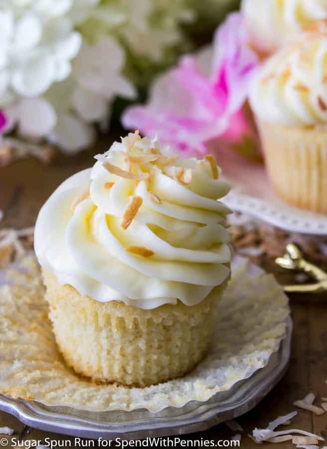 Coconut cupcakes are soft, fluffy cupcakes (I provide a both a from-scratch recipe and the option to use a box-mix!), topped off with a cream cheese based coconut buttercream frosting and then sprinkled with lightly toasted coconut!