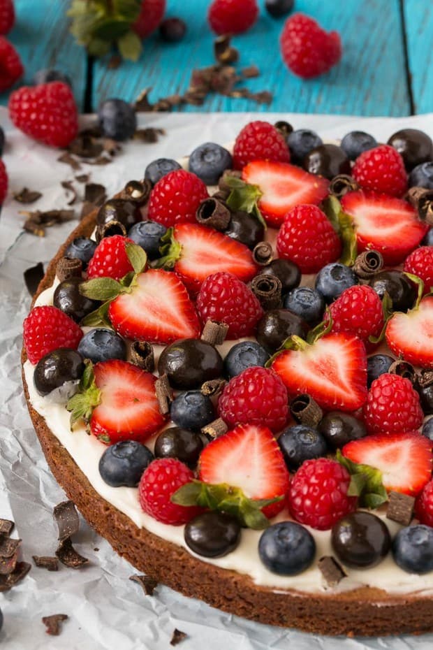 A rich brownie crust topped with cream cheese frosting and lots of fresh berries.