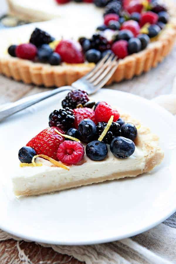 A Lemon Berry Mascarpone Tart is a simple, delicious way to show off all the season’s best berries. A creamy mascarpone filling, a hint of fresh lemon, and four kinds of berries, all on top of a sweet shortbread crust!