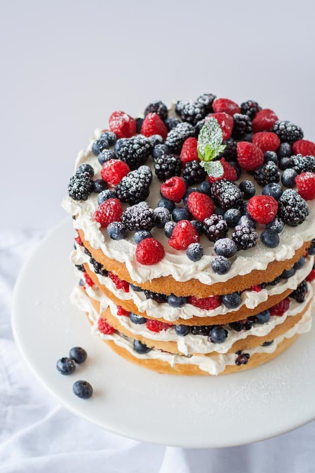 Summer berries are the best. Pretty and plentiful, it’s hard not to make a berry dessert (or multiple) during the hot, sunny months. This berry layer cake is an impressive yet super easy dessert to make, I promise! All you need is a cake of some kind (from scratch or a box mix, vanilla or chocolate), frosting of your choice (a simple vanilla buttercream or cream cheese frosting, etc.), and fresh berries. Then all you have to do is stack, and your impressive summer dessert is done!