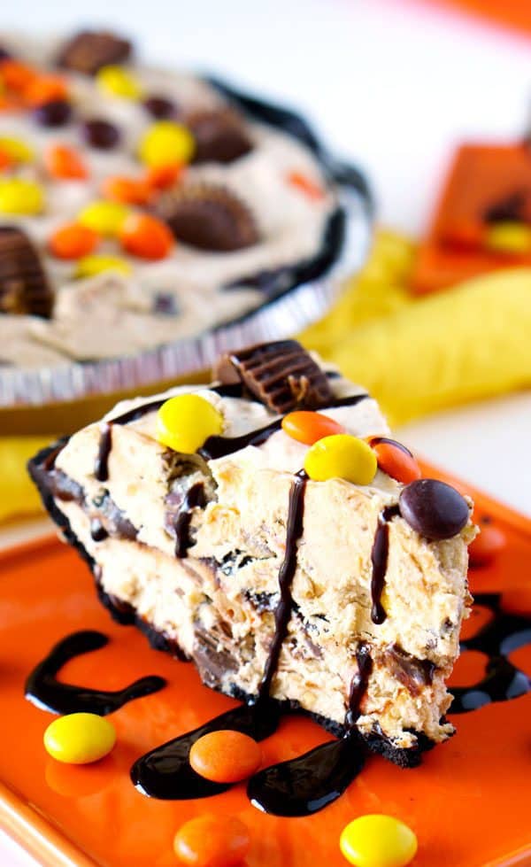 This Frozen Peanut Butter Pie is so easy to make, soft, creamy, and loaded with Reese’s Pieces and Reese’s Peanut Butter Cups. Basically, it’s the Peanut Butter Pie of your dreams!