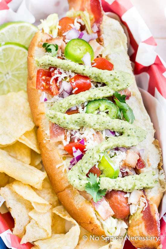  Hot dogs fully loaded with traditional BLT toppings – bacon, lettuce, tomato – PLUS, tex-mex garnishes, such as jalapenos and an avocado cream sauce!