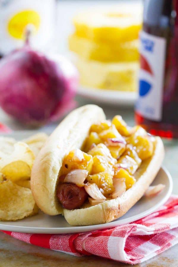 Take a taste of the tropics with these Hawaiian Hot Dogs – grilled hot dogs topped with grilled fresh pineapple and onions for a Hawaiian flair.