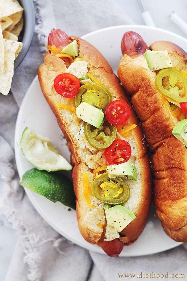 Nacho Hot Dogs: Cheesy and crunchy Nacho Hot Dogs packed with tortilla chips, jalapenos, avocado, tomatoes, and sour cream!