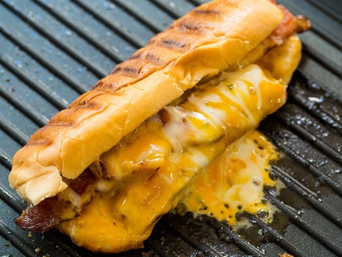 Grilled Cheese Hot Dogs are a super fun and tasty combination of 2 classics- Grilled Cheese and Hot Dogs. A buttery, crispy hot dog bun encases a grilled hot dog with lots of melty cheese and crispy bacon. Lunch doesn’t get any better than this!