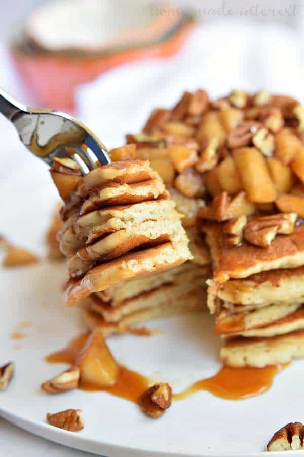 These Caramel Apple Pecan Pancakes are a fall breakfast recipe made with light and fluffy pancakes topped with caramel sauce, baked apples, and pecans.