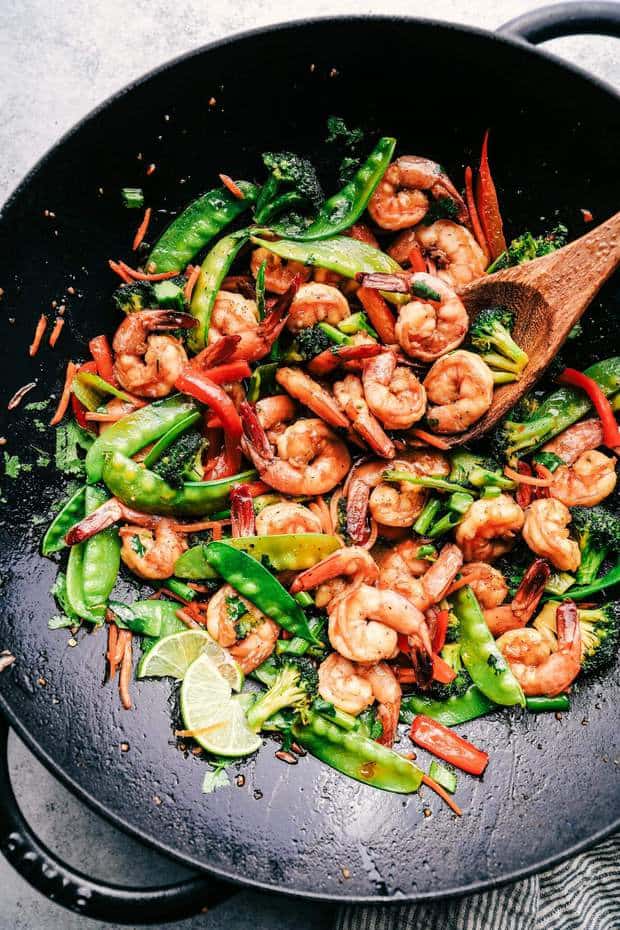 This Garlic Shrimp Stir Fry is one of the easiest meals that is packed with so many delicious veggies and shrimp.  Glazed in the most amazing garlic sauce, this will become an instant favorite!