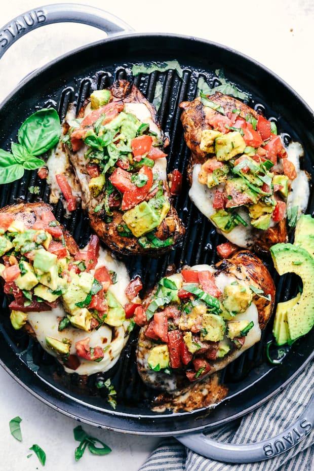Grilled California Avocado Chicken marinates in an amazing honey garlic balsamic sauce and is grilled to perfection! It is topped with a thick slice of mozzarella cheese and avocados, tomatoes and basil. This chicken is INCREDIBLE!! 