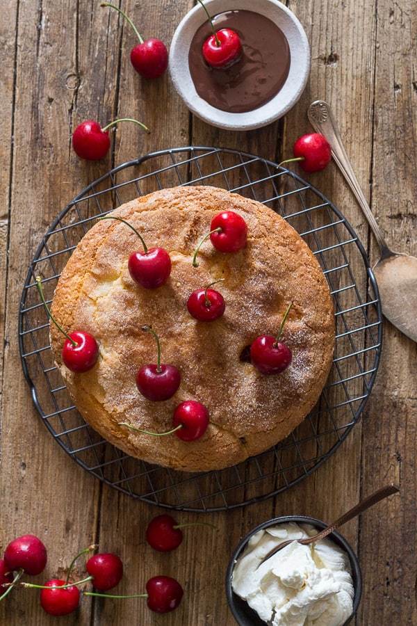 This fast and easy cherry cake is deliciously moist, made with yogurt and bursting with fresh cherries. Serve it plain or with a dollop of whipped cream and a fresh chocolate dipped cherry!