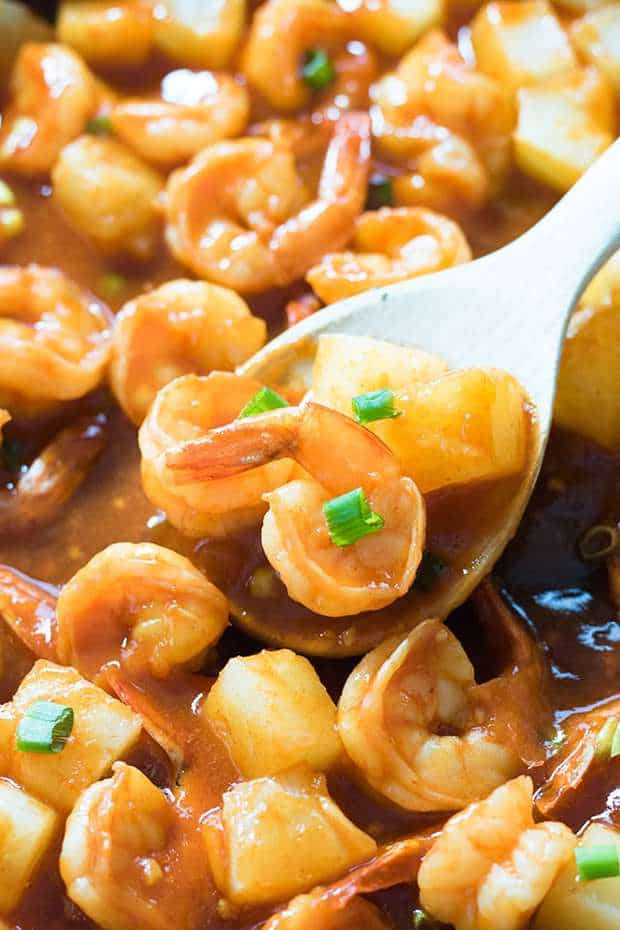 Pineapple Garlic Sweet Chili Shrimp - This easy shrimp recipe is ready in 15 minutes or less!  Shrimp sauteed with a spicy and sweet chili garlic sauce with chunks of pineapple.