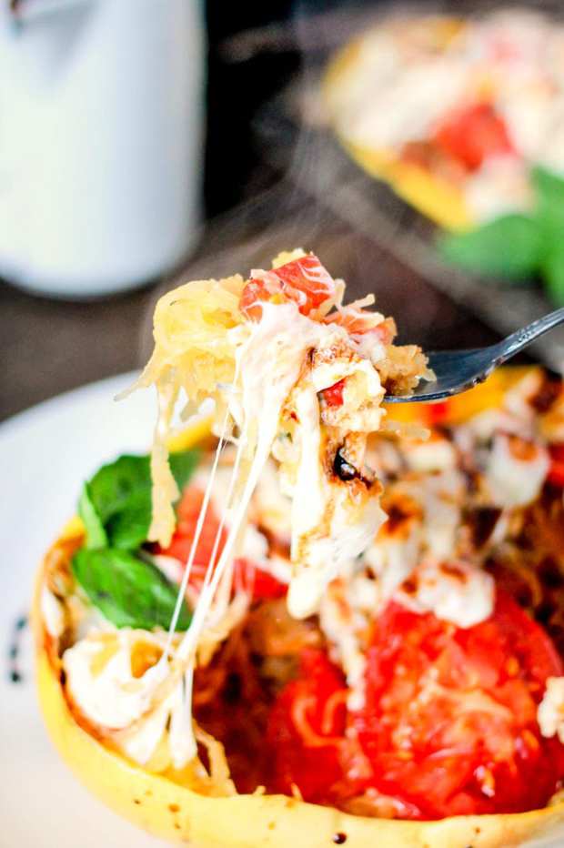 Caprese Stuffed Spaghetti Squash is loaded with fresh mozzarella, tomatoes, basil, and then topped with a delicious balsamic glaze! Perfect healthy dinner!