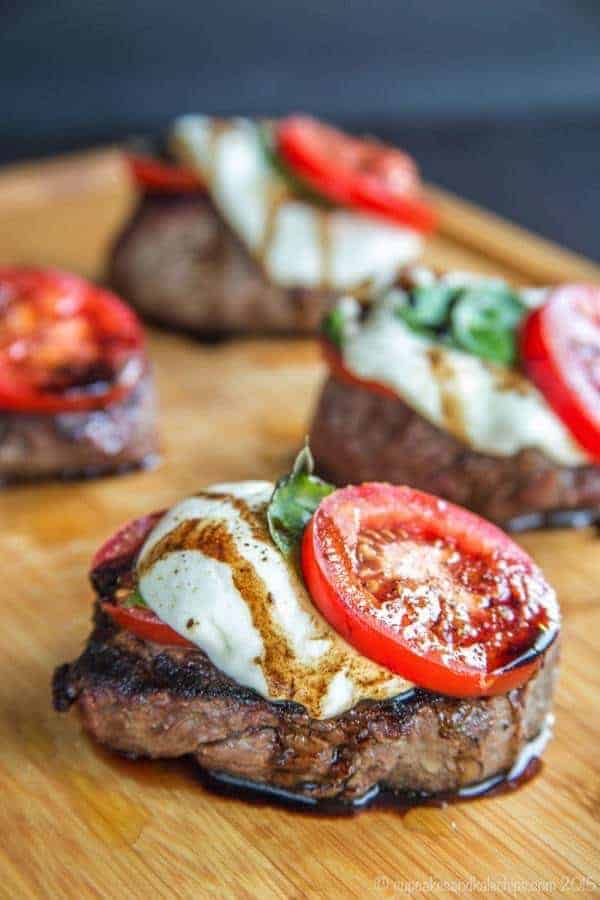 Caprese Grilled Filet Mignon is a simple way to dress up some amazing Certified Angus Beef brand filets with some of the freshest ingredients of summer. After simply seasoned with salt and pepper and grilling filet mignon, it is then topped with juicy tomatoes, fresh mozzarella, basil, and a balsamic reduction for an easy dinner recipe that is also a little extra special. This filet mignon recipe is not only delicious, it is also naturally gluten free and low carb.