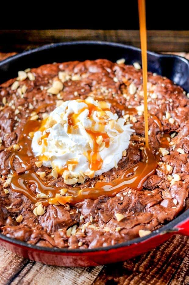 Snickers Skillet Brownies are ooey-gooey and full of chocolate, peanuts, and caramel. So easy to make and seriously delicious!