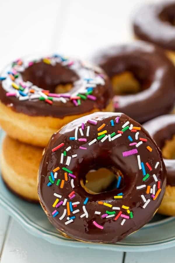 Chocolate Frosted Donuts with Sprinkles – soft and pillowy yeasted doughnuts covered with a decadent chocolate glaze and festive sprinkles.