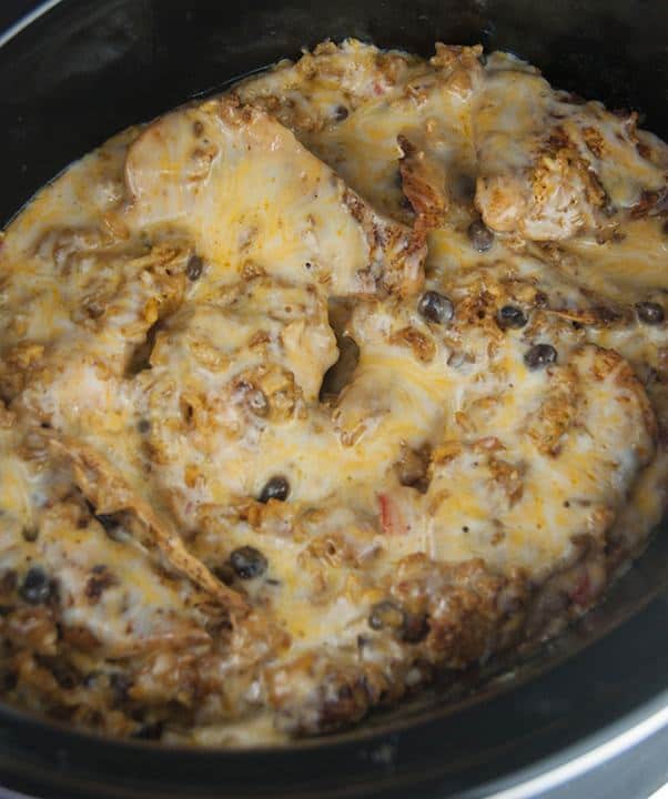 Crock Pot Fiesta Mexican Chicken & Rice recipe is an easy, creamy, cheesy chicken dish to make for dinner. Throw everything in your slow cooker and have a hot homemade meal on the table in no time at all!