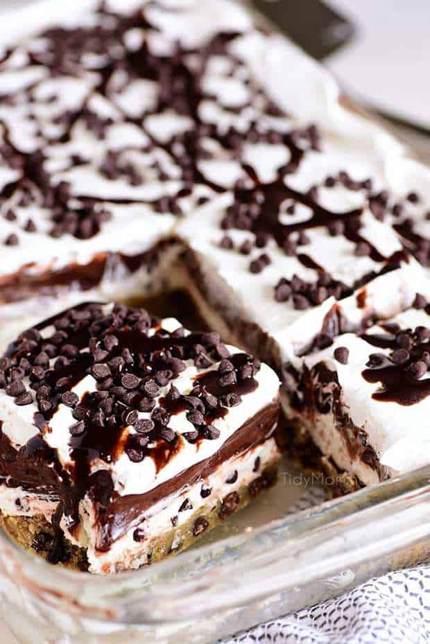 Chocolate Chip Cookie Layered Delight is four layers of pure bliss. This chilled dessert starts with a chocolate chip cookie bottom topped with a sweet cream cheese layer, chocolate pudding, and a creamy topping with more chocolate chips! This is the dessert recipe of your dreams!!