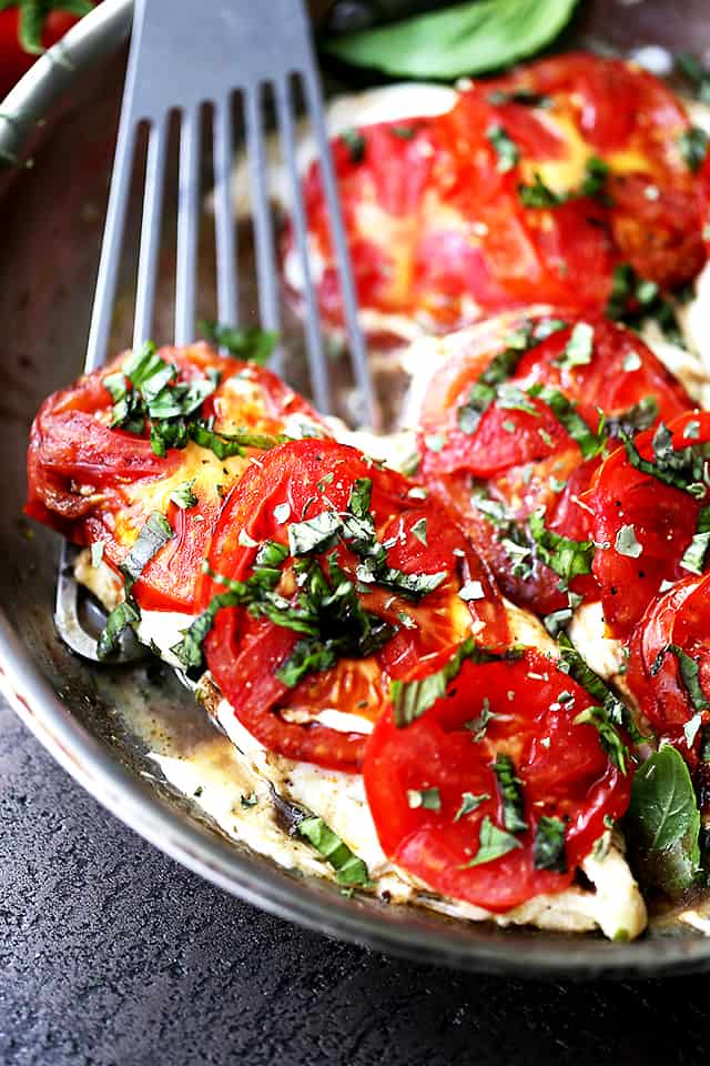 Caprese Skillet Chicken Recipe – Pan-seared chicken topped with melting mozzarella cheese, fresh tomatoes, a sprinkle of basil, and a drizzle of balsamic vinegar. Quick, easy, and SO delicious!