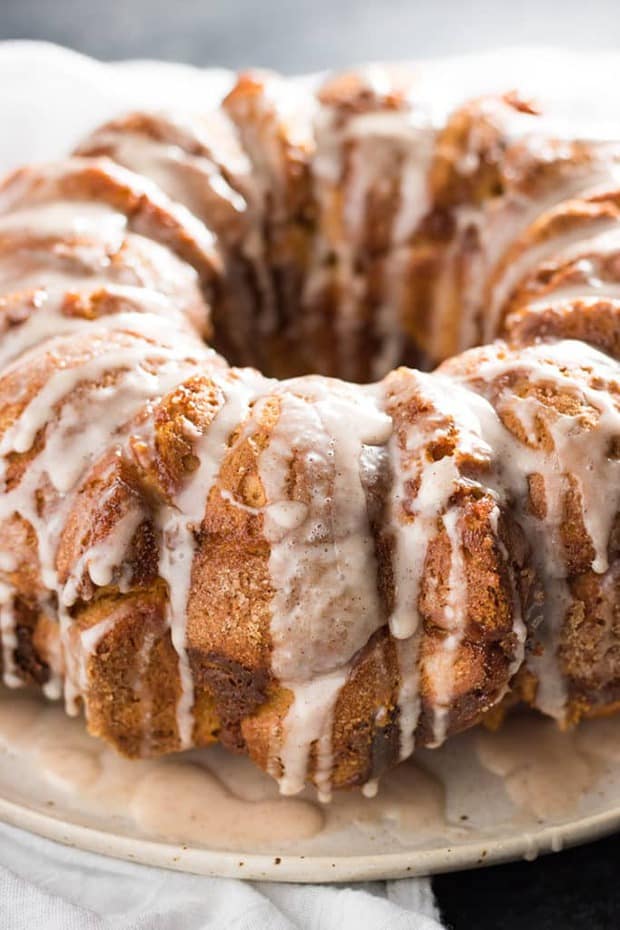 The classic pull apart monkey bread is given a twist of fall pumpkin spice flavor!  Still super easy to make with refrigerator biscuits, packed with pumpkin flavor, and topped with a decadent cinnamon glaze!