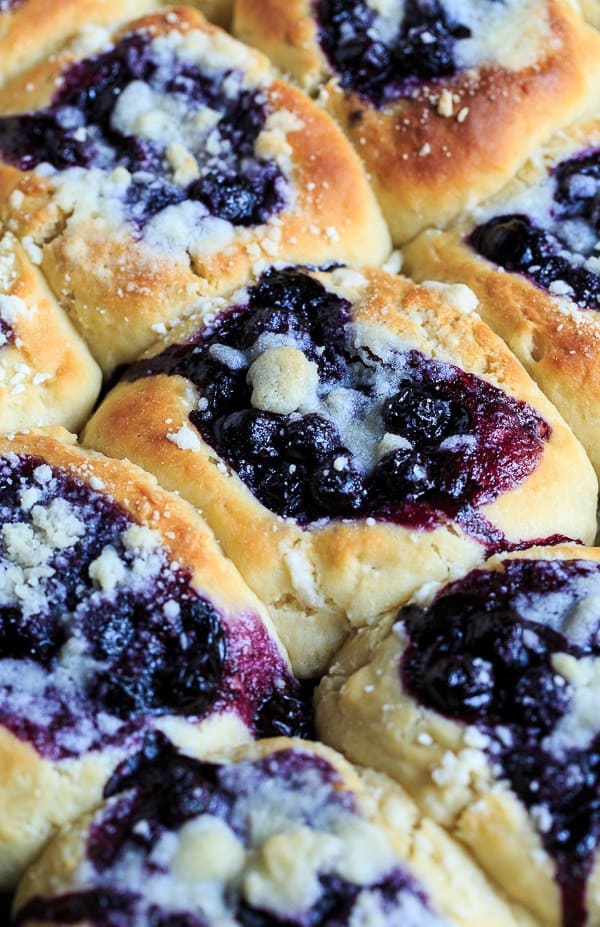 Blueberry Kolaches are made from a sweetened yeast dough and filled with a simple, fresh blueberry filling and a streusel topping. They are as tasty as they are pretty.