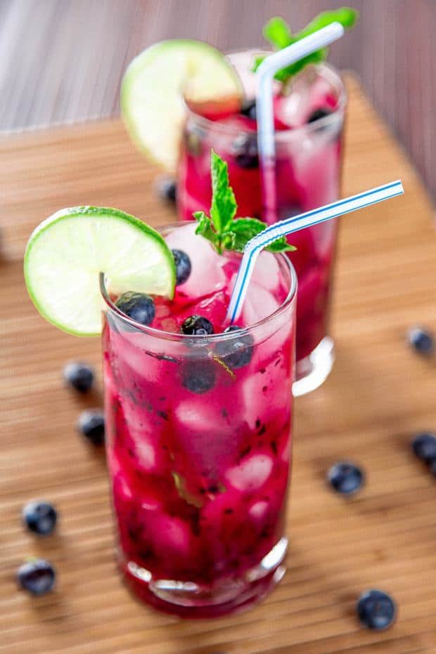 Blueberry Mojito: Cool off this summer with sweet blueberries, tart limes, and a refreshing splash of rum.  This cocktail will sweep you away like a cool island breeze & is perfect for lazy summer afternoons!