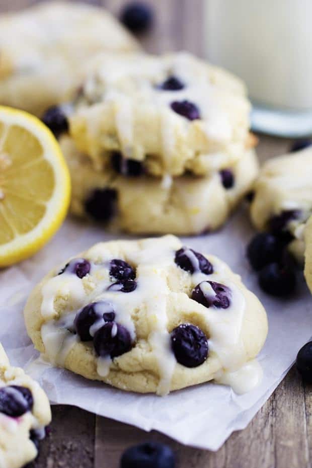 Perfect moist and puffy cookies with fresh blueberries bursting inside.  These cookies are a mix between a blueberry muffin and a soft and chewy cookie.  Drizzled in a lemon glaze, these will become a new favorite!
