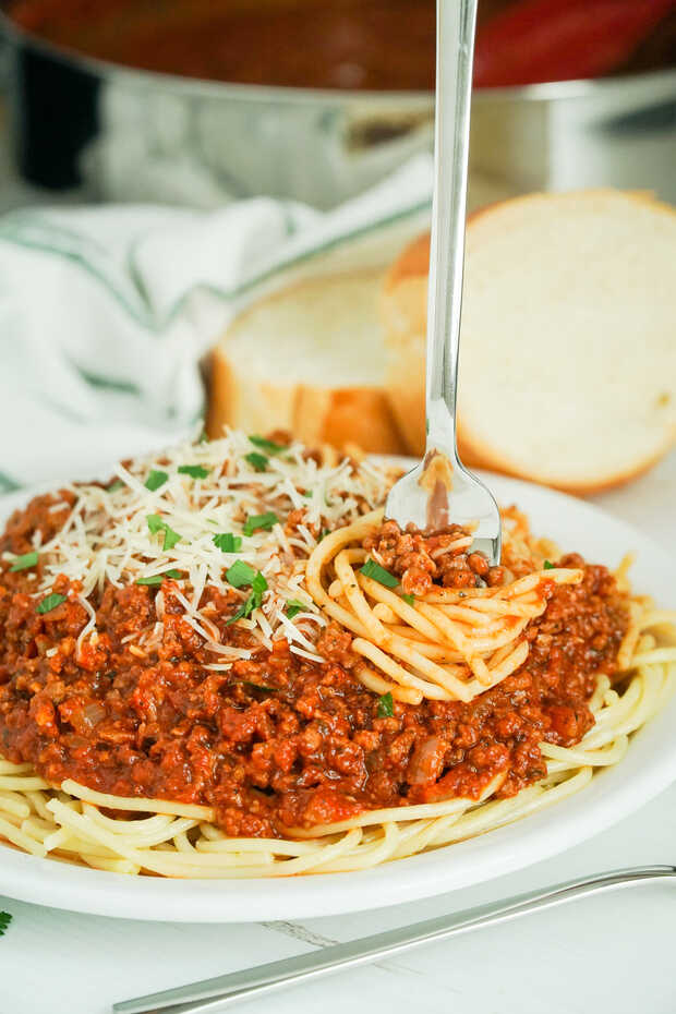 A plate of food on a table, with Spaghetti and Sauce