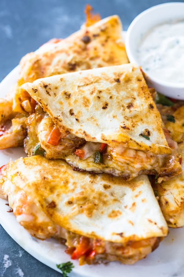 A close up of a plate of food, with Quesadilla and Chicken