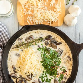 A bowl of food on a table, with Mushroom and Cream