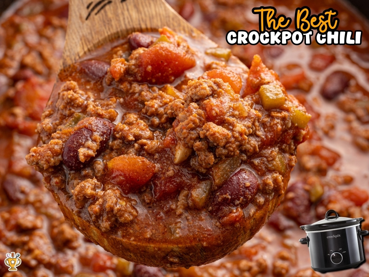 Close-up of a ladle filled with thick crockpot chili made with ground beef, kidney beans, tomatoes, and peppers.
