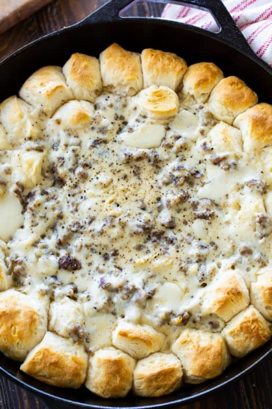 A pan filled with food, with Gravy and Sausage
