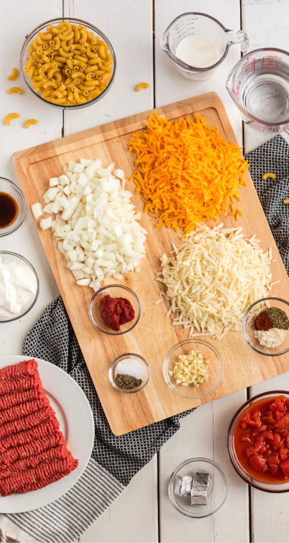 A bunch of food on a plate on a table, with Cheese and Burger