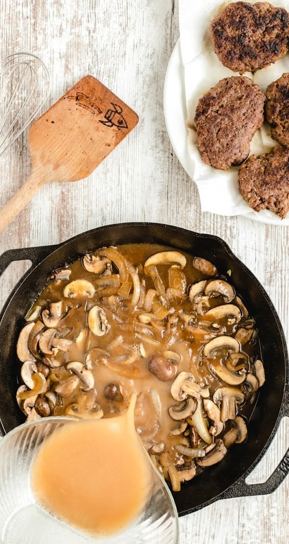 A bowl of food, with Salisbury steak and Gravy