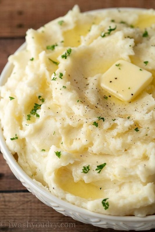 A dish is filled with food, with Cream and Potato