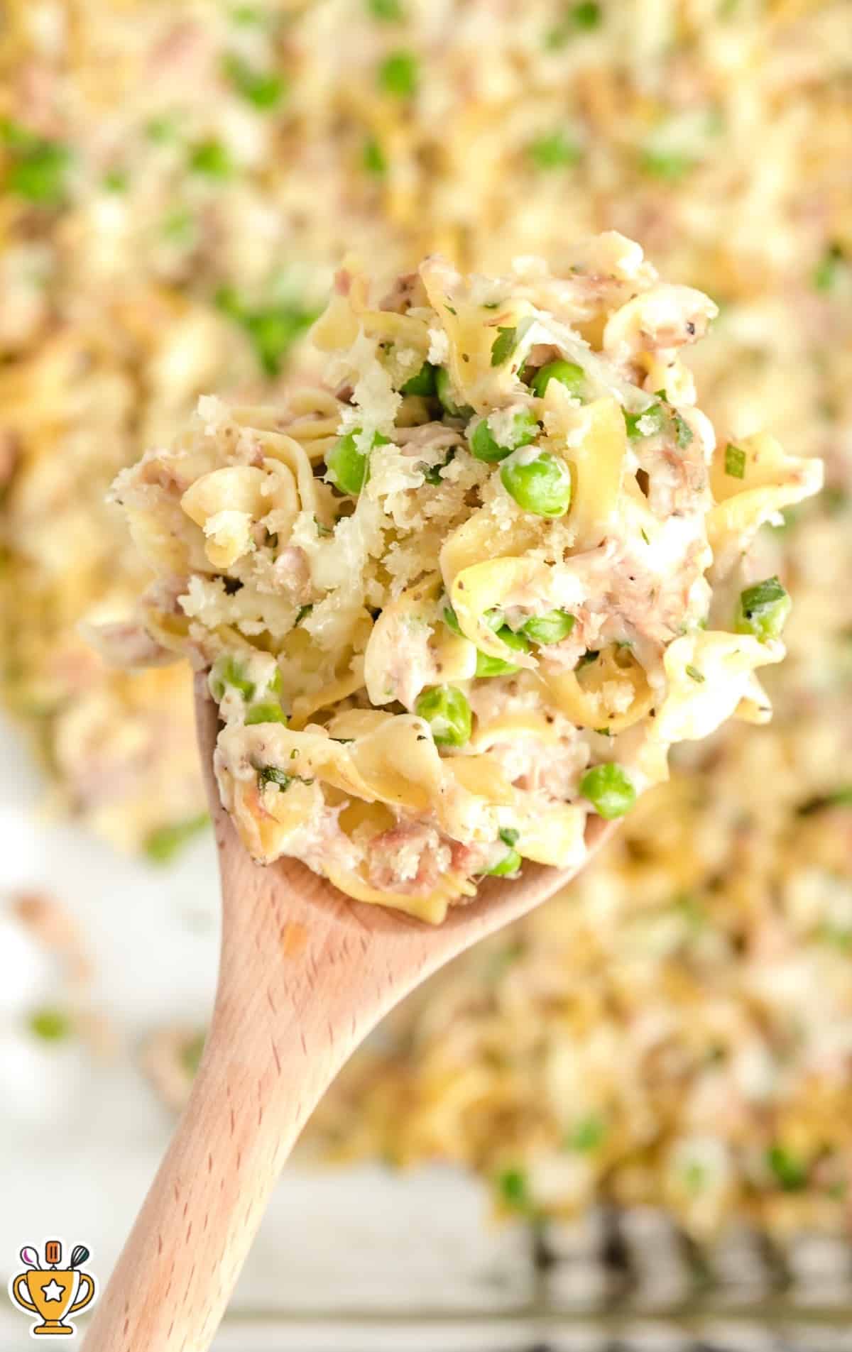 a wooden spoon holding some Tuna Casserole
