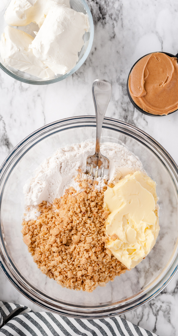 crushed dry roasted peanuts, flour and margarine in mixing bowl
