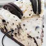 A piece of chocolate cake on a plate, with Oreo and Cheese