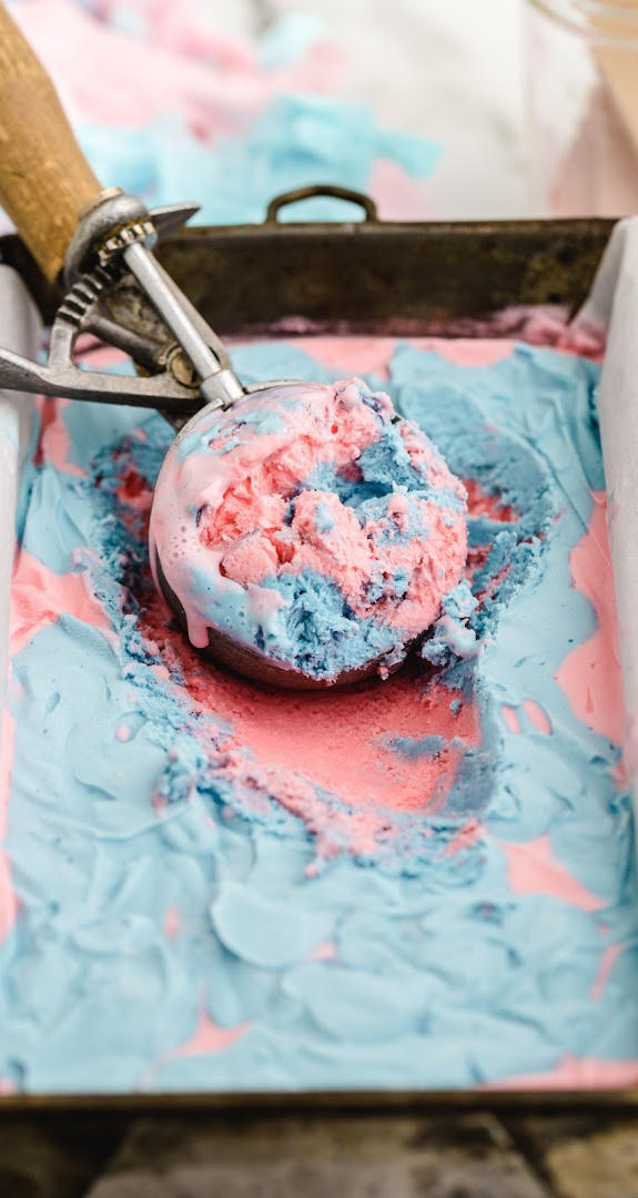 scooping cotton candy ice cream out of pan