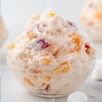 southern ambrosia salad in a clear glass bowl that is ready to eat