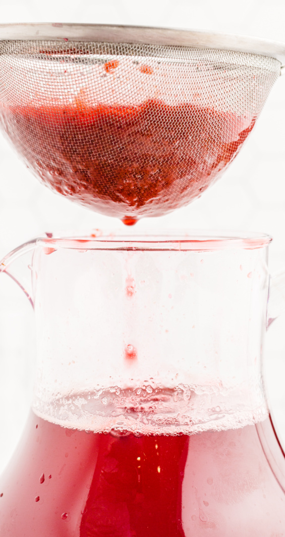 Pour the berry juice through a screen sieve into the tea mixture