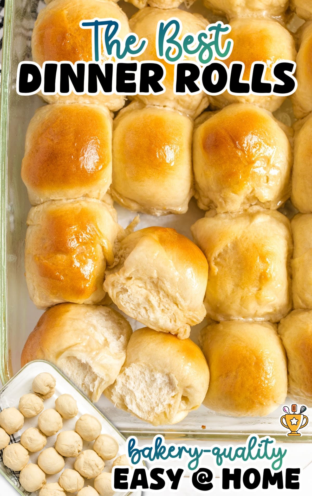 Close-up of buttery homemade dinner rolls baked to a soft golden finish in a glass pan, with fluffy interiors visible where rolls are torn open for a bakery-style dinner roll recipe.