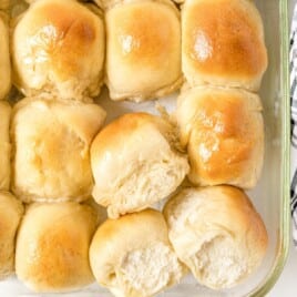 Recipe card image showing homestyle dinner rolls with ingredient list and baked rolls in glass dishes, highlighting an easy from-scratch yeast dinner roll recipe with soft, buttery results.