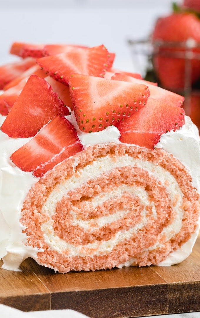 A piece of cake on a plate, with Strawberry and Cream